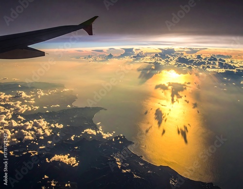 Aerial view of sunset over a body of water from an airplane
