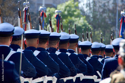 Chilean Air Force soldiers marching in a military parade in the street.