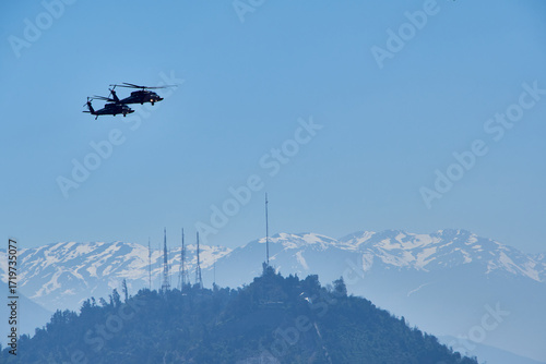 two air force helicopters flying in the sky