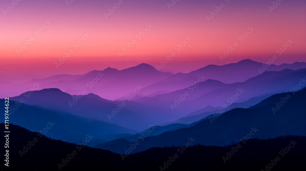 Obraz premium A serene mountain range at sunrise, layers of purple and pink hues blending in the sky