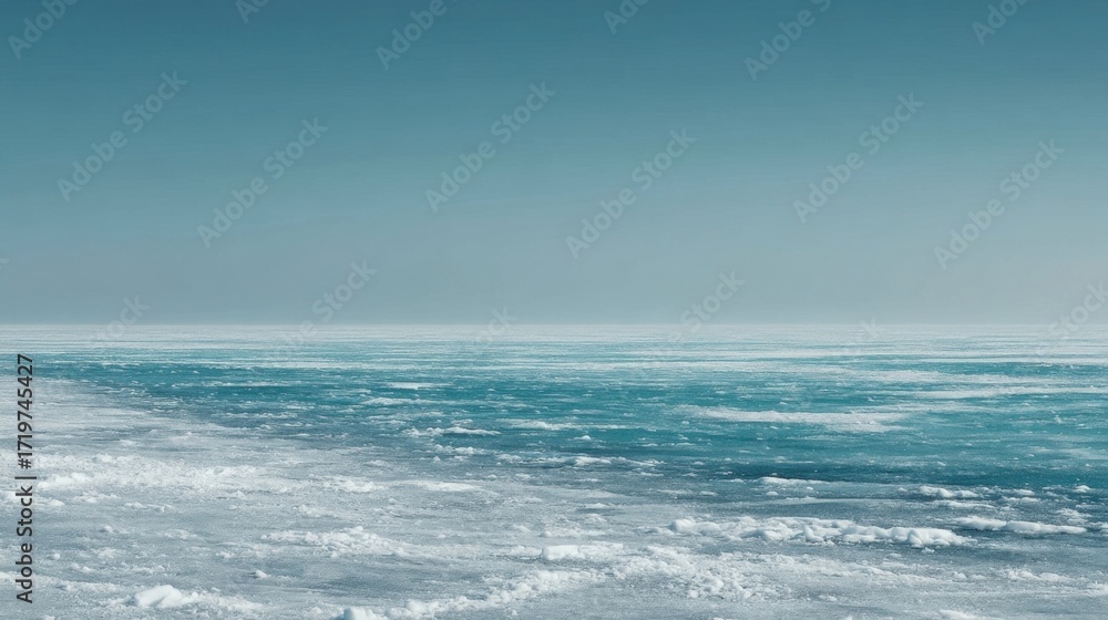 Fototapeta premium A vast icy landscape features dense textured ice sheets with intricate patterns and crevasses,