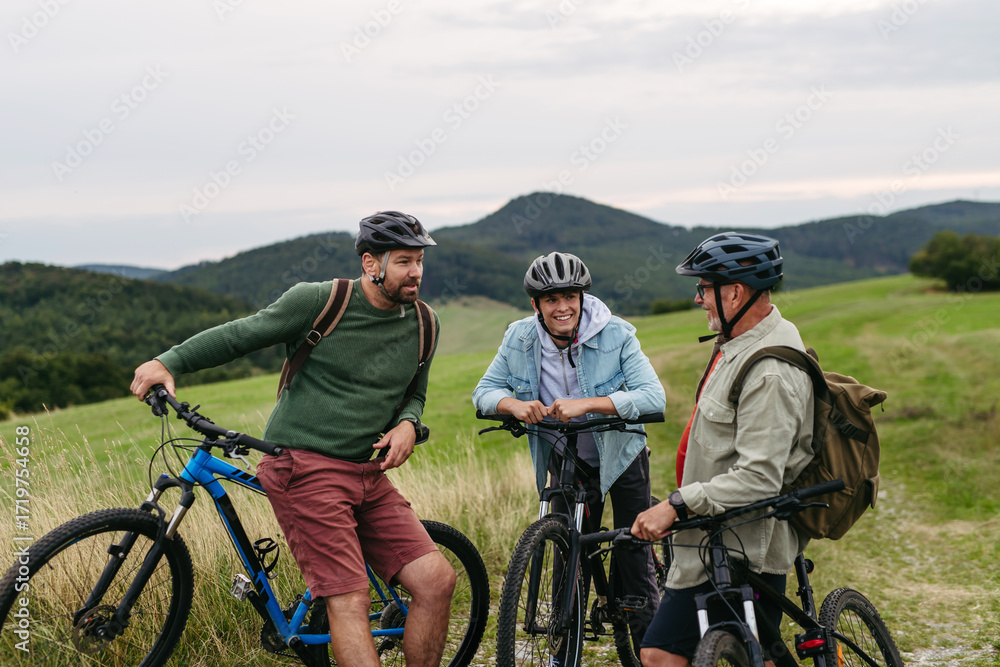 Fototapeta premium Grandfather, father and teen boy on cycling trip taking selfie.