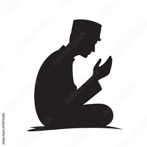 Man performing islamic prayer in a dark silhouette
