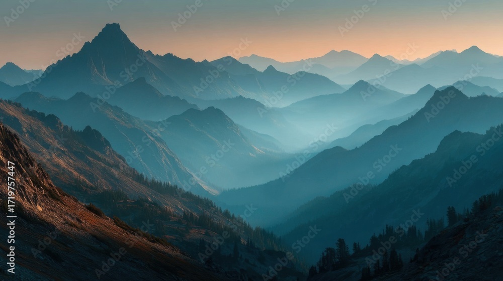 Fototapeta premium A sweeping view of a valley with a prominent range of mountains rising up in the background under clear blue skies.