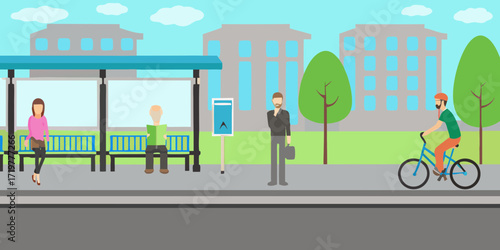 People waiting at a bus stop and a man riding a bicycle in a city with buildings and trees