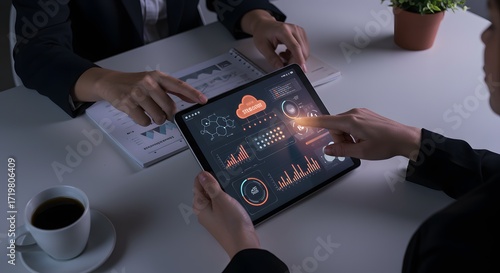 Business meeting with digital analytics on tablet and charts