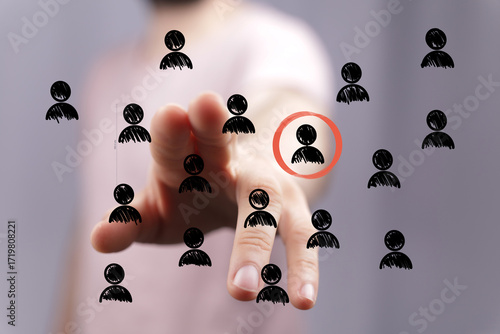 Hand pointing at a person i...