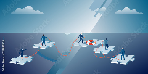 Business team collaborating and building a bridge across a chasm using puzzle pieces and a life preserver for support