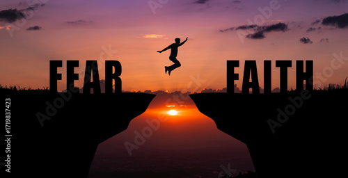 Silhouette of a person jumping from fear to faith over a gap between cliffs at sunset, symbolizing courage, trust, personal growth, resilience, overcoming doubts, inner strength, and belief in oneself