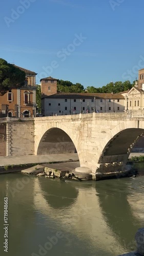 The Tiber River flows under the Cestius Bridge near Tiber Island in central Rome.