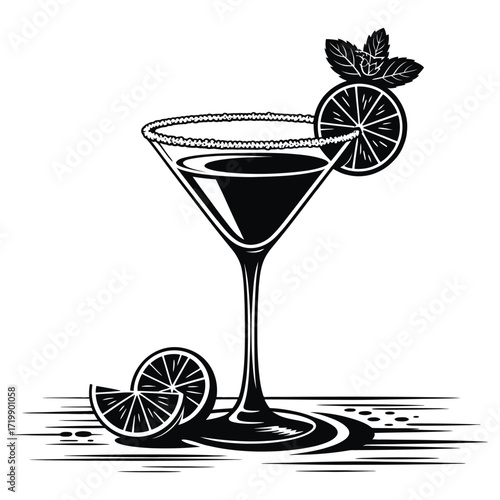 Elegant martini glass with lime and mint garnish on a wooden surface