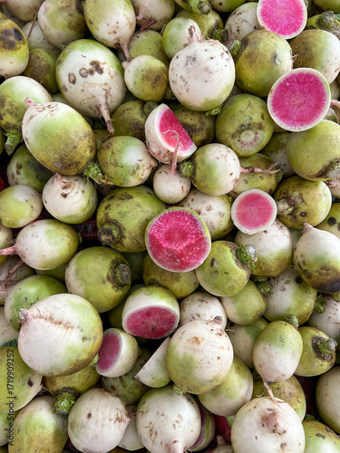 Fresh radishes with pink interior displayed at market
