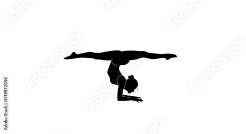 Silhouette of a woman practicing yoga in a handstand position, demonstrating strength, balance, and flexibility