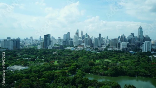 An aerial view of bangkoks skyline with lush green parks in the foreground