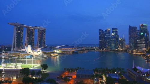 Singapore skyline at night with marina bay sands and skyscrapers reflecting in water
