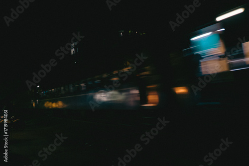 Blurred Night Train Moving Through City
