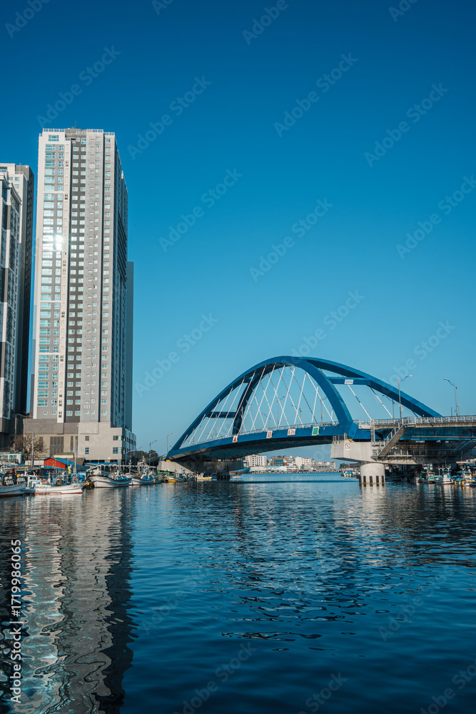 Fototapeta premium Sokcho harbor with fishing boats and modern skyscrapers, South Korea