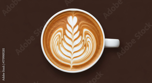 Latte art in a white cup on a brown background, top view.