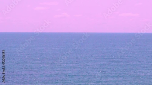 Beautiful Sunset Clear Lilac Sky with Plump Clouds over Blue Sea. Colorful Sunrise Pink Sky and Ocean, Seascape. Aerial View Sea Horizon Part Lilac Sky Cloud Part Blue Sea Bay Travel Vacation Nobody.