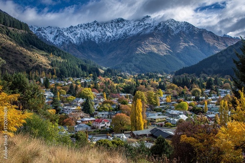 Scenic Mountain Village in Autumn with Snow-capped Peaks and Colorful Foliage