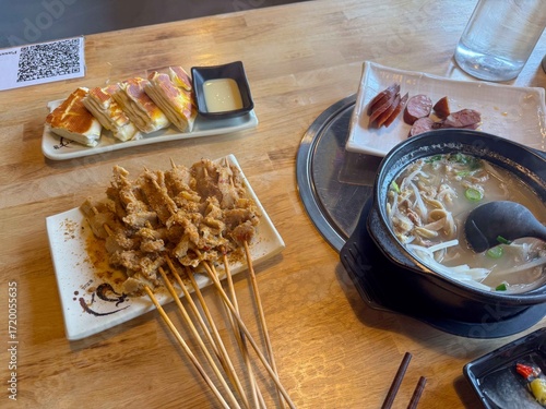 Chinese lamb guts skewers with white soup and sausages.