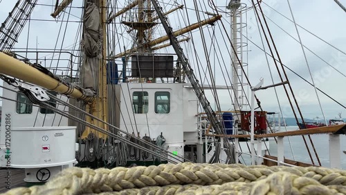 Three-masted sailing vessel. A flying seagull among sea ropes