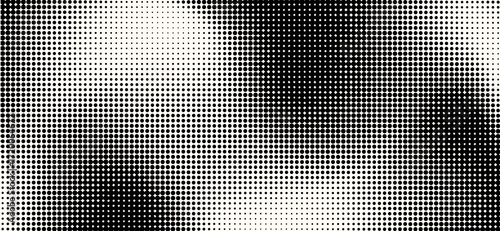This high-contrast image showcases a halftone pattern of densely packed black dots gradually fading into a bright white background, creating an abstract and modern design with dynamic shading