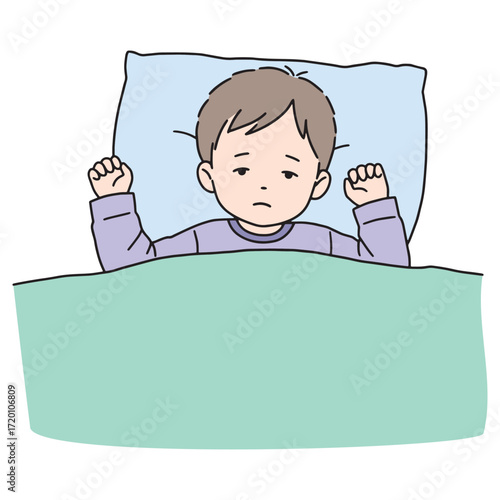 Young boy lying in bed, struggling to wake up, feeling tired and unmotivated