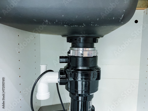 A kitchen sink that has a garbage disposal unit installed underneath it for grinding food waste, making it easier to dispose of leftovers and keep the kitchen clean and organized