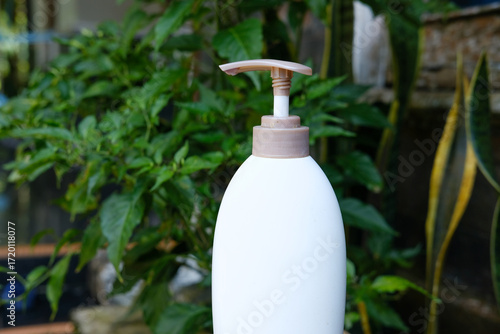 White Pump Bottle with Outdoor, Lush Greenery, and Hygiene.