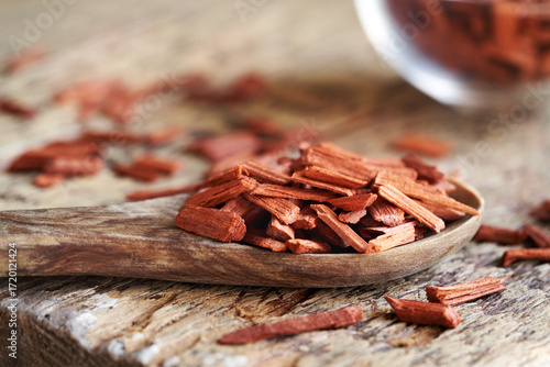 Red sandalwood chips on a spoon on a table