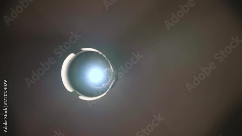 POV of person feeling bad because of high blood pressure, person having dizziness, then losing consciousness, the scene of spinning dim lamp with some mist in dark room, disorientation and confusion
