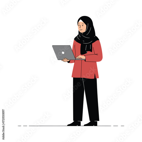 A Muslim woman wearing a hijab and a red tunic stands holding a laptop computer.