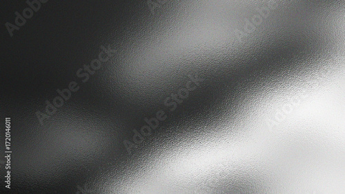 Abstract textured background with a gradient of dark gray to bright white suggesting light and shadow play