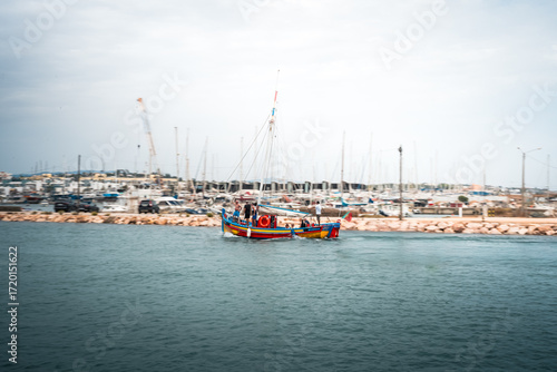 Touristic boat arriving in the marina of Lagos, Portugal