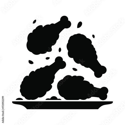 Crispy fried chicken drumsticks falling onto a plate