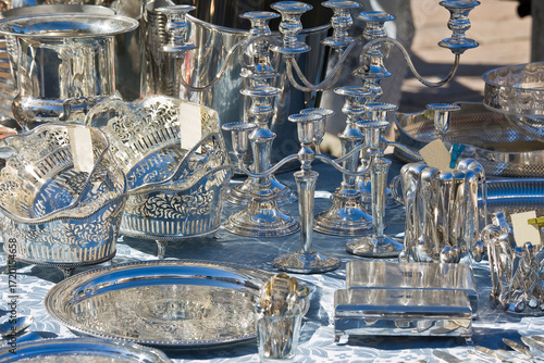 ANTIQUE SILVERWARE FOR SALE AT FLEA MARKET SYMBOL OF LUXURY AND HERITAGE - Vintage craftsmanship, wealth, elegance and refinement concept in collectible silver items on display