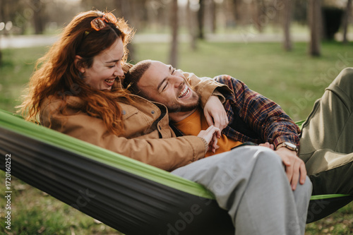 Photography A cheerful couple enjoying leisure time in a hammock amidst the serene setting of nature