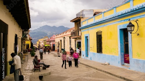 People stroll along a vibrant street in san cristobal de las casas, mexico