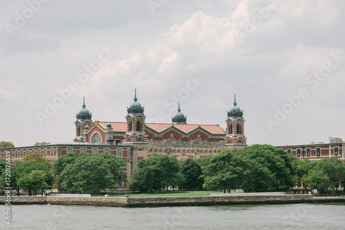 Photos Historic Ellis Island showcases stunning architecture against a cloudy sky with