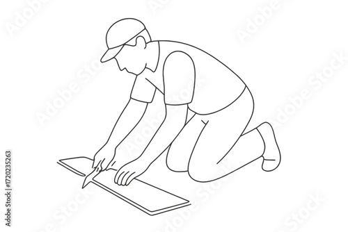 Man kneeling while cutting laminate with a utility knife on the floor  