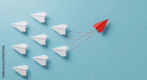 A red paper airplane leads a formation of white paper airplanes against a blue background from a top-down viewpoint