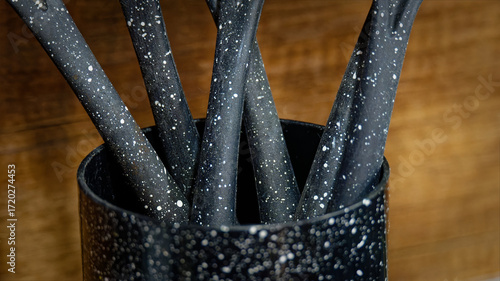 Used black with white dots plastic kitchen utensils
