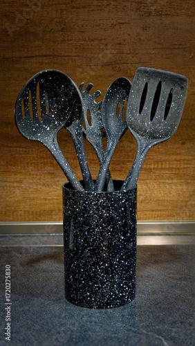 Used black with white dots plastic kitchen utensils