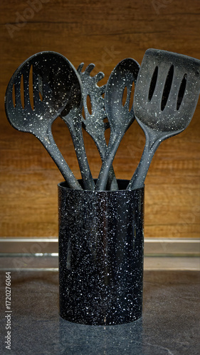 Used black with white dots plastic kitchen utensils