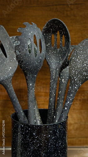 Used black with white dots plastic kitchen utensils