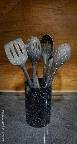Used black with white dots plastic kitchen utensils