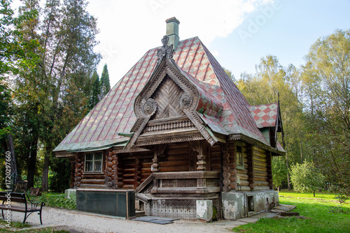 Wooden log house with a beautiful facade with carved architraves on a clear sunny day. Sights of Russia, World tourism.