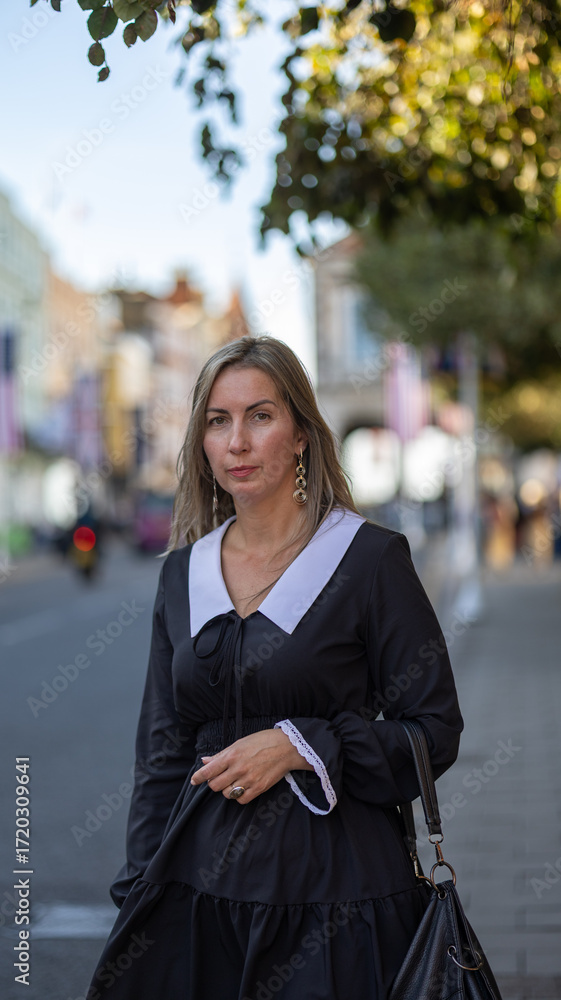 Fototapeta premium Portrait of a Woman Outdoors on a City Street