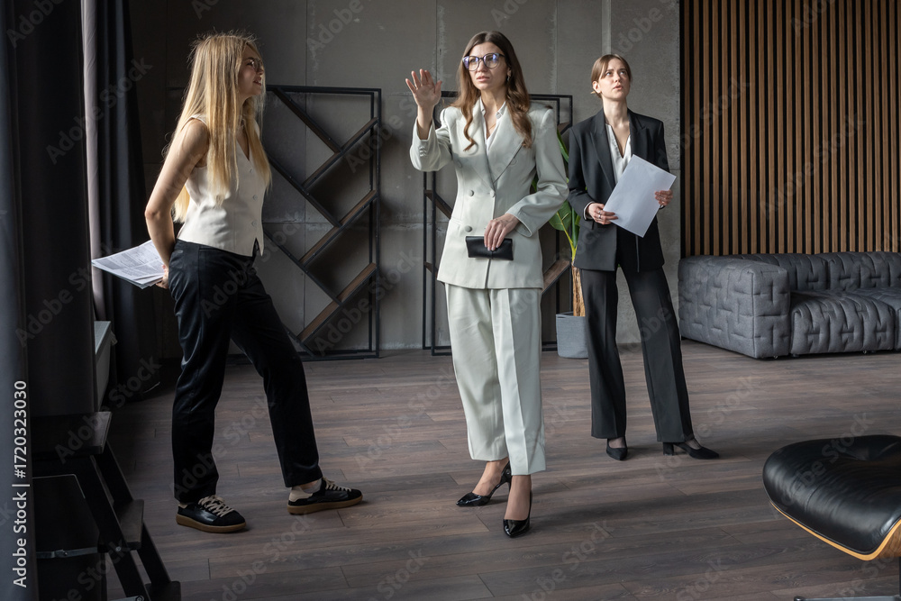 custom made wallpaper toronto digitalGroup of professional women in office during meeting, one pointing at window while colleagues listen, teamwork and planning concept.